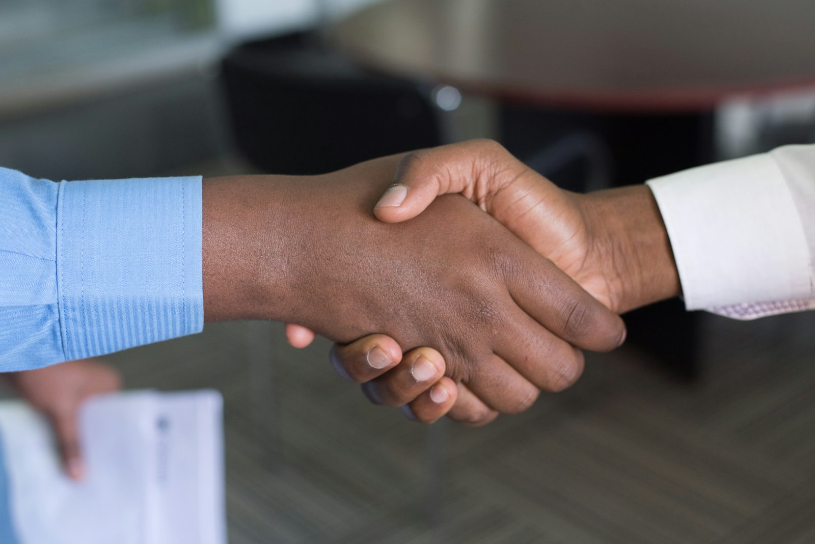 A close handshake between two people in business dress